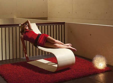 chaise longue design Onda avec une jeune femme avec une robe rouge allongée dessus